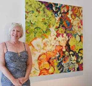 Christine Reimer, Canadian Painter with her canvas, "Life Beyond the Hive"